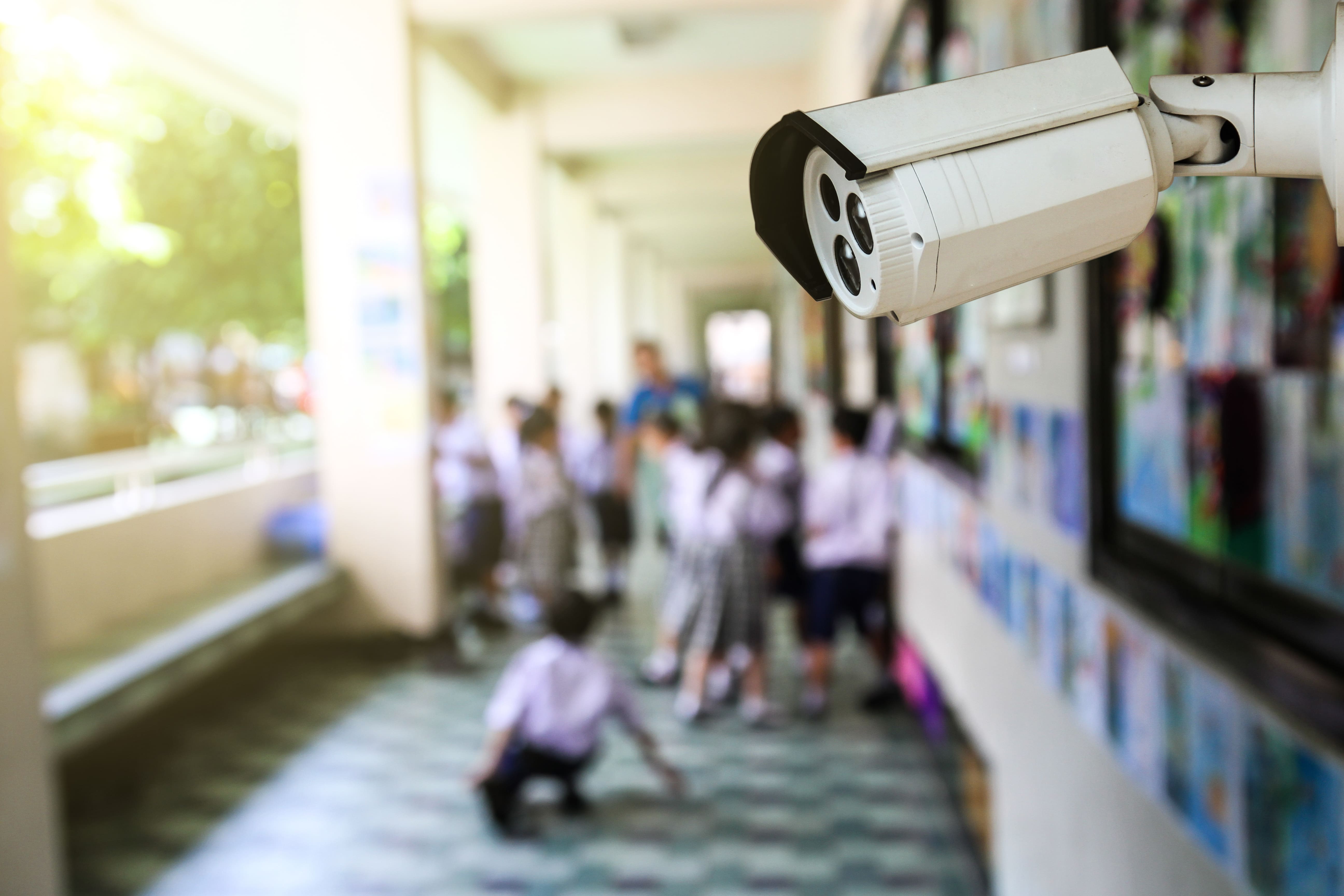 image of CCTV camera overlooking school children playing outside 