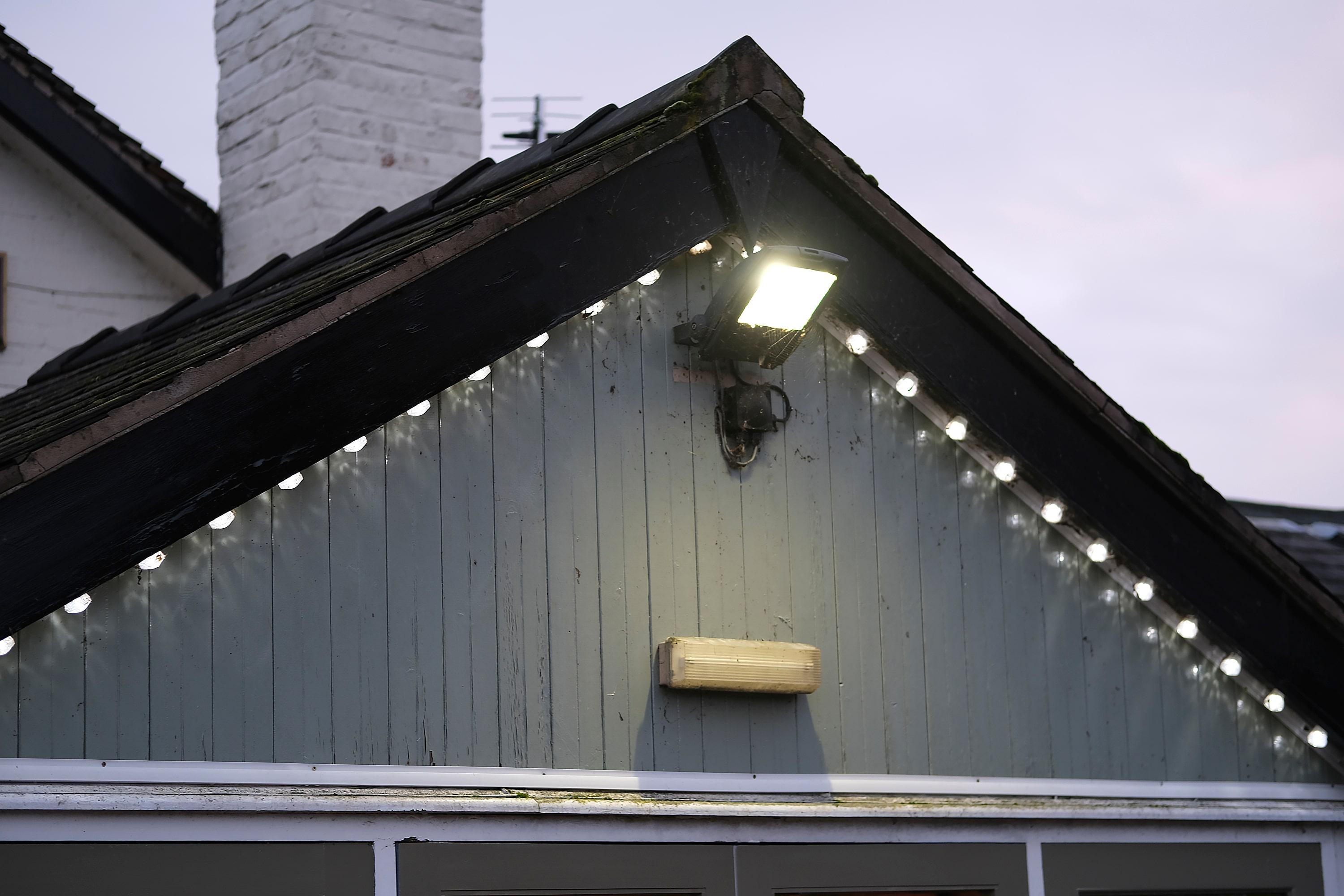 Is Your Property More Secure Than a Shed_ (Take This Colchester Home Security Quiz to Find Out) A modern home exterior at dusk with CCTV cameras and motion lights visible