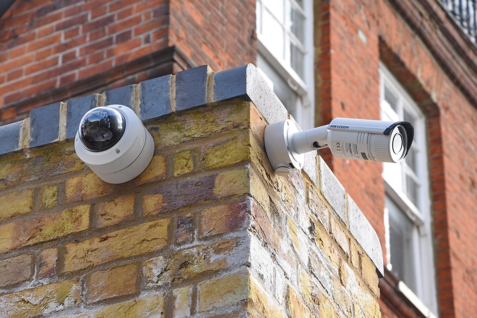 Two CCTV cameras on brick wall for “How often should CCTV be serviced” blog by Lenz Security